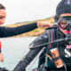 Scuba diving instructor helping a diver to learn how to dive