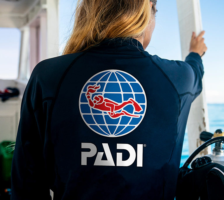 scuba diving divemaster holding herself on a seat during a working day