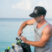 diving instructor securing a nitrox tank before starting the advanced open water diver course