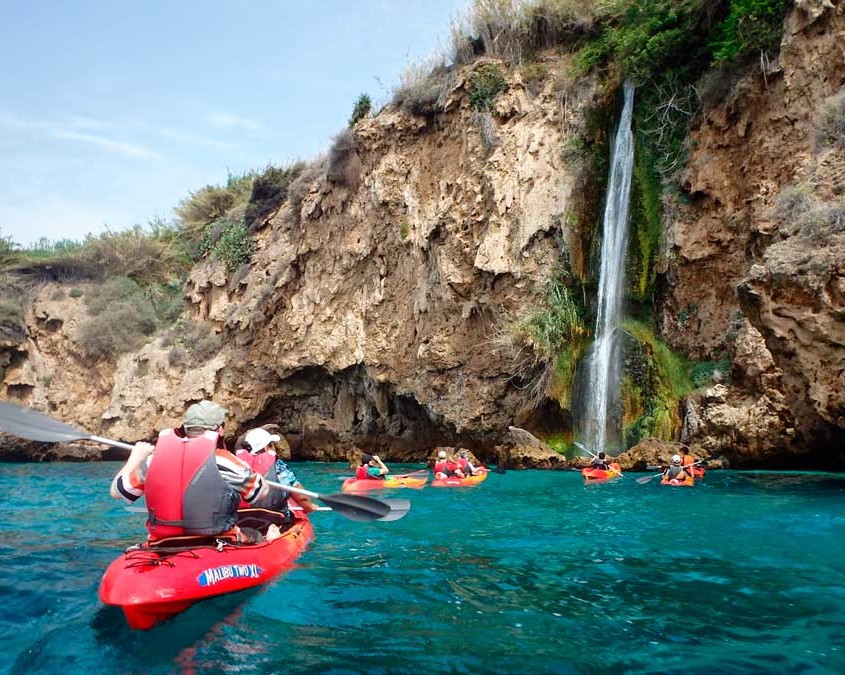 People with life jackets , paddling on a kayak in the sea, in maro Cerro Gordo