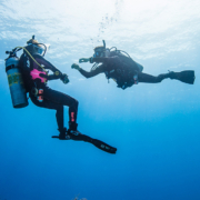 Scuba diving instructor training a beginner diver in the sea in south Spain